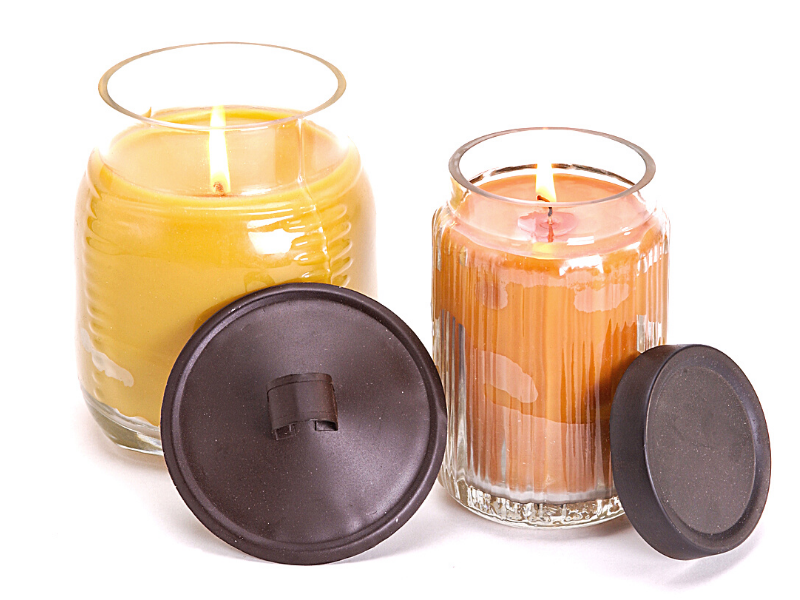orange and burnt orange colored candles burning with dark bronze lids leaning on jars, luxury scented candles, scented candles benefits, scented candles for bedroom, scented candles amazon, scented candles cheap, soy candles, non toxic candles for pregnancy, non toxic candles target